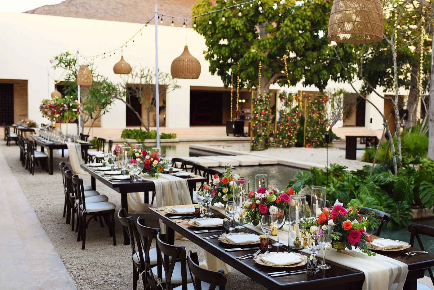 Destination wedding reception with floral tables and hanging lanterns